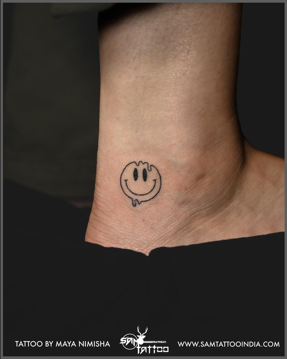 Minimal smiley tattoo